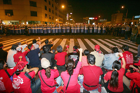 Demonstrators shout at riot police during a rally calling for President Chen Shui-bian to step down, in Taipei October 11, 2006. 