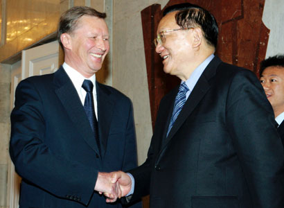Russian Defence Minister Sergei Ivanov (L) shakes hands with China's top envoy on North Korea, Tang Jiaxuan, in Moscow October 14, 2006. Sanctions on North Korea should not even hint at at a use of military force, Ivanov was quoted by Russian news agencies as saying.