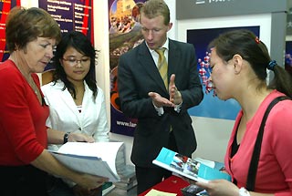 Staff from Britain's Lancaster University introduce the school to Chinese students at the China Education Expo 2006, held over the weekend in Beijing. 