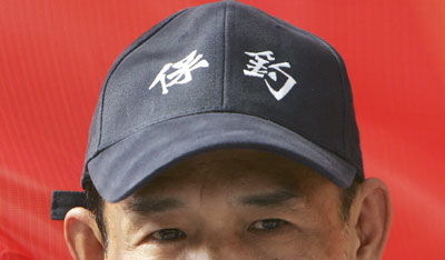 An activist from the Hong Kong-based Action Committee for Defending the Diaoyu Islands watches as a vessel, which will sail to a group of disputed islands in the East China Sea, sets sail in Hong Kong October 22, 2006.