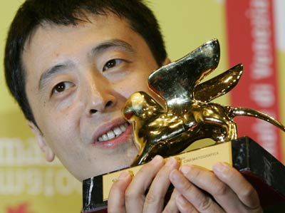 Director Jia Zhang-ke poses with the Golden Lion at the Cinema Palace in Venice September 9, 2006. Zhangke's movie 'Still Life' won Venice Film Festival's Golden Lion top prize on Saturday.
