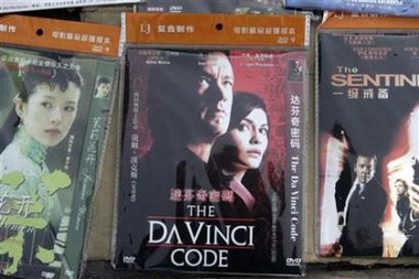 A pirated DVD version of 'The Da Vinci Code' movie is displayed for sale along a sidewalk in Beijing in this May 22, 2006 file photo. China sentenced a man to life in jail on Thursday for running what state media called the country's biggest ever pirate film disc smuggling ring. 