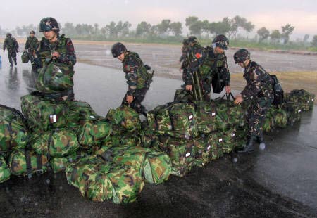 China's People's Liberation Army troops prepare their luggage after their arrival at a military base in Rawalpindi near Islamabad December 10, 2006. Traditional allies Pakistan and China will hold joint military exercises this week aimed at helping the two countries fight terrorism, the Pakistani military said on Sunday.