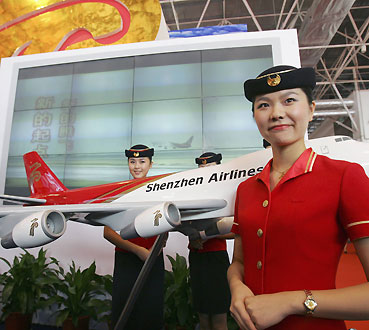 Flight attendants from China's Shenzhen Airlines pose on the first day of the 6th China International Aviation & Aerospace Exhibition in Zhuhai in China's southern Guangdong province in this October 31, 2006 file photo. 