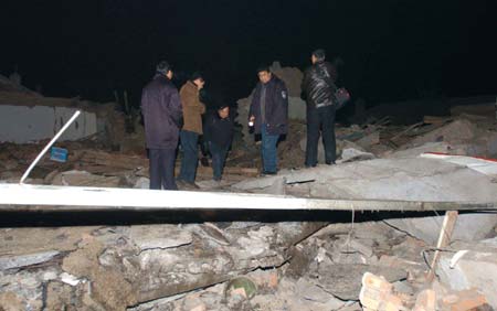 Chinese policemen inspect the site of explosion in a residential area in Ulanqab City, North China's Inner Mongolia Autonomous Region, December 28, 2006. Five people died and eight were injured in two consecutive explosions in Jining District of Ulanqab City, Xinhua reported. A preliminary investigation said the accident was caused by detonator explosion. [Xinhua]