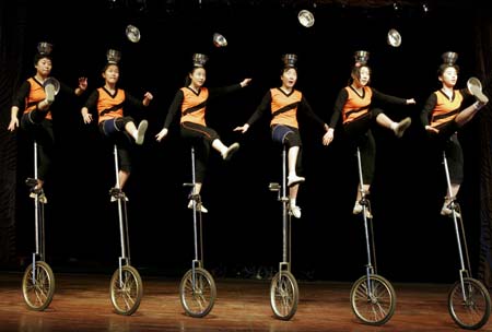 Acrobatic troupe trains with bowls in Shenyang, northeastern China's Liaoning province December 28, 2006. 