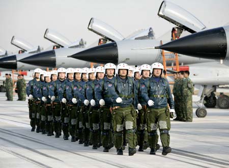 Chinese air force pilots walk in front of J-10 fighter planes at a military base December 18, 2006. The air force has been equipped with the new generation of fighters, independently designed by China. The fighter has the 