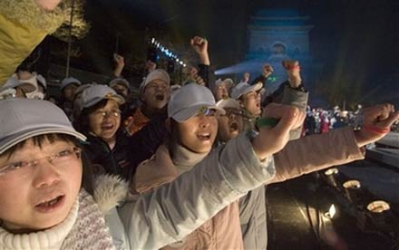 Chinese teenagers celebrate the new year during a event launching colored wrist bands for the 2008 Olympic Games held to coincide with a new year count-down in Beijing, China, Monday, Jan 1, 2007. 