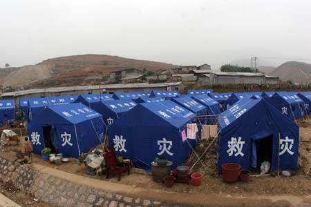 A general view shows some houses collapse following a cave-in at Haijie Village, Nuotong Township, Guangxi Zhuang Autonomous Region, January 3,2007. The cave-in was caused by underground work on a nearby railway tunnel. Nobody was injured in the accident and some 257 villagers were evacuated to safe areas. [newsphoto]