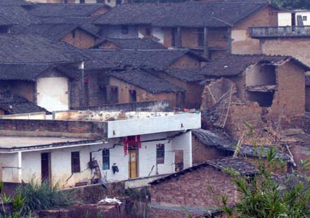 A general view shows the tents built by relief authorities following a cave-in at Haijie Village, Nuotong Township, Guangxi Zhuang Autonomous Region, January 3,2007. The cave-in was caused by underground work on a nearby railway tunnel. Nobody was injured in the accident and some 257 villagers were evacuated to safe areas. [newsphoto]