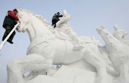 Workers prepare a snow sculpture at a park for the upcoming China Harbin international ice and snow festival in Harbin, northeastern China's Heilongjiang province, January 4, 2007. 
