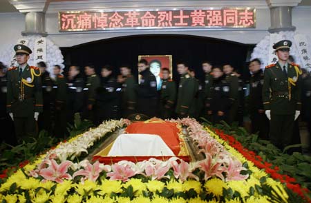 Mourners file past the casket of Huang Qiang, a 21-year-old policeman who died in a raid to a terrorist camp, during a memorial service in Urumqi, northwest China's Xinjiang Uygur Autonomous Region, January 9, 2007. Police have destroyed a terrorist camp, killing 18 terrorists and capturing 17 others.[newsphoto]