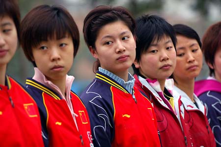 Zhang Yining (2nd L) and other players of China's National Women Tennis Team stand in formation during one-month intensive training in Zhongshan, South China's Guangdong Province, January 11, 2007. The players received the military training once a week during their training in Zhonshan. [Xinhua]
