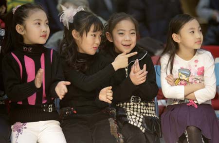 Participants in a child modelling competition watch the performance of other contestants in Beijing January 13, 2007. The competition was held at the end of a model training course for about 200 children aged 4 to 16, during which they underwent physical training and received instruction on stagecraft and various kinds of dances such as step dance and ballet.