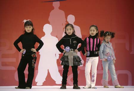 Participants in a child modelling competition perform onstage in Beijing January 13, 2007. The competition was held at the end of a model training course for about 200 children aged 4 to 16, during which they underwent physical training and received instruction on stagecraft and various kinds of dances such as step dance and ballet. 