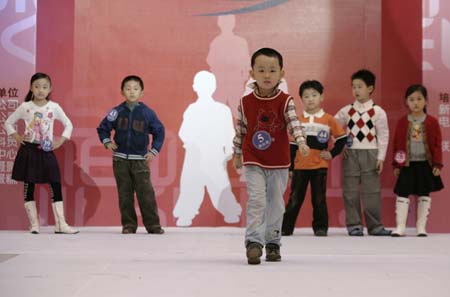 Participants in a child modelling competition perform onstage in Beijing January 13, 2007. The competition was held at the end of a model training course for about 200 children aged 4 to 16, during which they underwent physical training and received instruction on stagecraft and various kinds of dances such as step dance and ballet. 