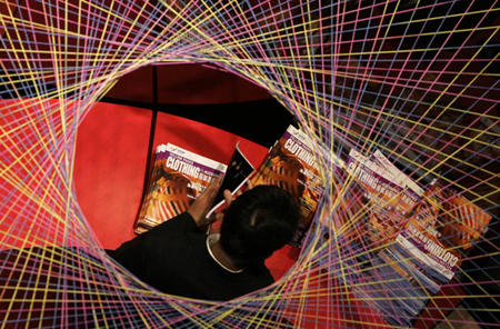 A man looks at magazines inside a booth during Hong Kong Fashion Week for Fall/Winter 2007, in Hong Kong January 15, 2007. 