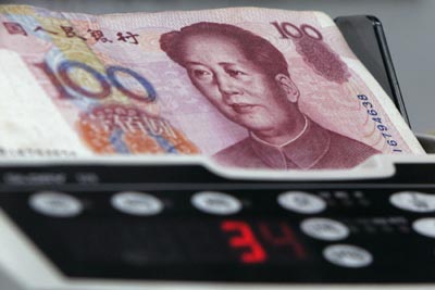 Yuan banknotes are counted at a currency exchange store in Hong Kong January 11, 2007. 