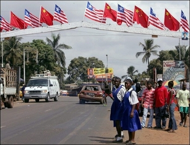 People stand in a street of the Liberian capital Monrovia, on the eve of the visit by Chinese President Hu Jintao. Hu is on a 12-day tour of Africa, his third since coming to power in 2003, stepping up China's campaign to win a larger share of Africa's oil and energy resources.(