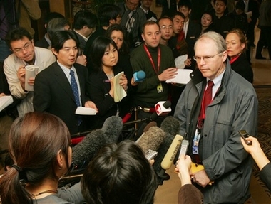U.S. Assistant Secretary of State Christopher Hill, right, speaks to journalists before heading out to six-party talks on North Korea's nuclear program in Beijing Tuesday, Feb. 13, 2007.