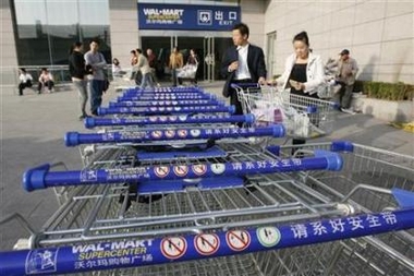 Shoppers emerge from a Wal-Mart Supercenter branch in Beijing October 17, 2006. 