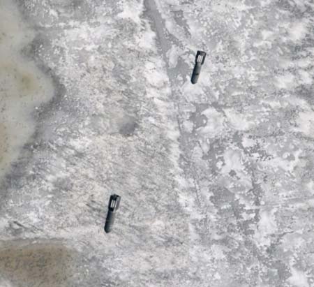 Two bombs fall on the floating ice at a section of the Yellow River in North China's Inner Mongolia Autonomous Region, March 7, 2007. Three planes from China's Air Force dropped 24 bombs on the floating ice that threatened the cofferdams.[newsphoto]