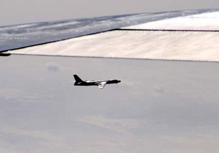 A fighter plane flies before bombing the floating ice at a section of the Yellow River in North China's Inner Mongolia Autonomous Region, March 7, 2007. Three fighter planes from China's Air Force dropped 24 bombs on the floating ice that threatened the cofferdams.[newsphoto]