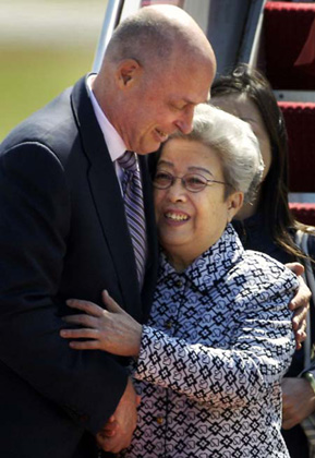 China's Vice Premier Wu Yi (R) embraces U.S. Treasury Secretary Henry Paulson upon her arrival at Andrews Air Force Base near Washington, May 21, 2007. 