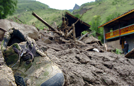 A shoes is seen after floods and landslides hit a village in Jiulong County, Southwest China's Sichuan Province, May 25, 2005. Twelve people were killed in floods and landslides triggered by rainstorms, Xinhua said. [www.xinhuanet.com]
