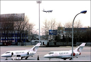 Two executive jets wait on the tarmac of Beijing Capital airport in 2000.