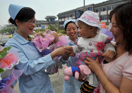 Quake babies reunite with nurse rescuers one year on