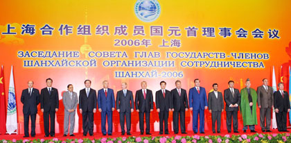 China's President Hu Jintao (C) poses with leaders during a group photo session at a summit of the Shanghai Cooperation Organization (SCO) in Shanghai June 15, 2006. The leaders include (from 5th L-3rd R) Uzbekistan's President Islom Karimov, Russia's President Vladimir Putin, Kazakhstan's President Nursultan Nazarbayev, Kyrgyzstan's President Kurmanbek Bakiyev, Tajikistan's President Imomali Rakhmonov, Iran's President Mahmoud Ahmadinejad, Pakistan's President Pervez Musharraf and Afghanistan's President Hamid Karzai.