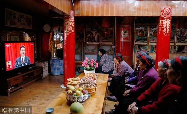 Tibetans gather to watch meeting