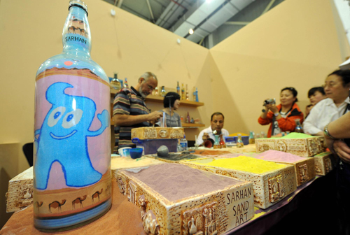 Brothers make sand art bottles at Expo