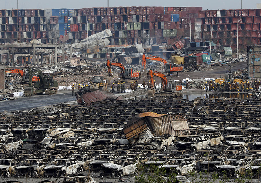 Burnt vehicles cleaned up in core blast area in Tianjin