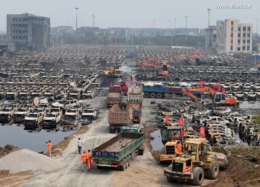 Burnt vehicles cleaned up in core blast area in Tianjin