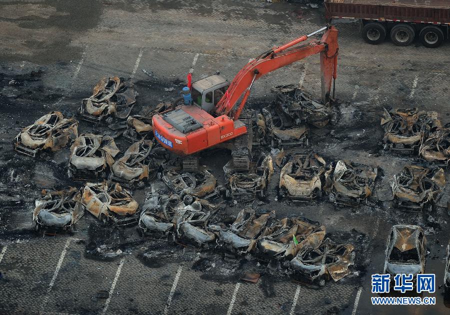 Burnt vehicles cleaned up in core blast area in Tianjin