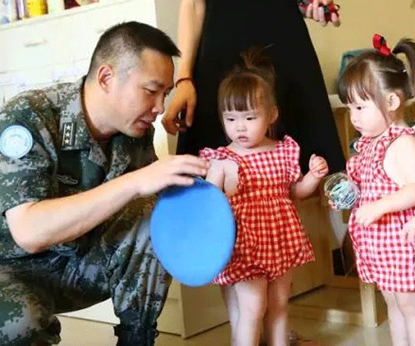 Daughters cry as dad heads abroad for peacekeeping