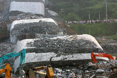 Rescuers search for survivors from the ruins of a collapsed bridge in ...