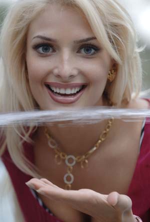 Miss Russia Tatiana Kotova plays with water in Sanya, south China's Hainan Province, Nov. 16, 2007. Contestants from 106 countries and regions will compete at the final of the 57th Miss World Competition in Sanya on Dec. 1.