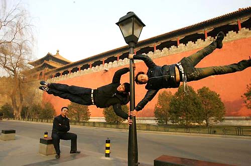 Parkour fans practice at a plaza in front of the Forbidden City in Beijing. [Photo: China Photo Press]