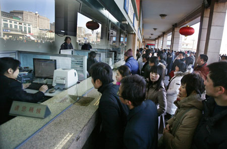 Chinese travellers queue to buy train tickets at Beijing Railway Station February 12, 2008. China is expected to see railway traffic peak on Tuesday, the last day of Spring Festival, as the Lunar New Year holiday is known, when millions head back to work from their hometowns. 'Post-Spring Festival railway traffic peak saw more than 5 million passengers in one day last year and we expect more in 2008,' Xinhua news agency quoted the Railways Ministry as saying. [Agencies]