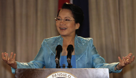Philippine President Gloria Macapagal Arroyo gestures during the observance of the International Women's Day celebration, which fall on Saturday, at the Malacanang presidential palace in Manila March 7, 2008. [Agencies]