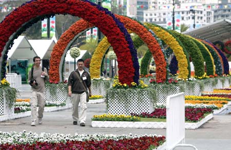 Journalists walk at the venue of the 2008 Hong Kong Flower Show in Hong Kong of south China on March 13, 2008. The show, organized by Hong Kong Leisure and Cultural Services Department, featuring exhibits of floral arrangements presenting the Beijing 2008 Olympic Games mascots, is scheduled to open on March 14 until March 24 in Victoria Park on Hong Kong Island. (Xinhua Photo)