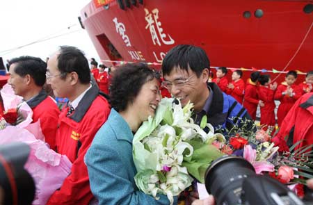 An expedition team member hugs his reletive after he arrives in Shanghai, east China, April 15, 2008. 