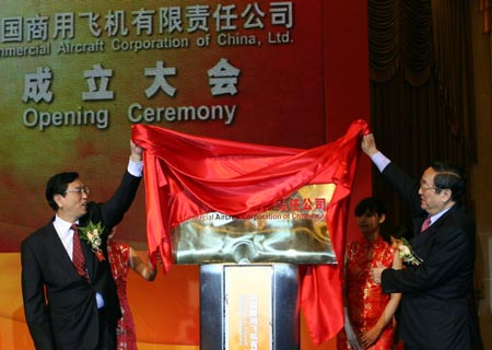 Chinese Vice Premier Zhang Dejiang (L) and Shanghai Party Chief Yu Zhengsheng (R) unveil the plaque for China's first ever jumbo passenger aircraft company at the inauguration ceremony in Shanghai, east China, May 11, 2008. China's first ever jumbo passenger aircraft company, which was a major part of the nation's large jet program, was officially inaugurated in Shanghai on Sunday. 
