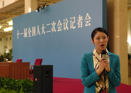 A journalist works prior to Chinese Foreign Minister Yang Jiechi&apos;s meeting with the press held by the Second Session of the 11th National People&apos;s Congress (NPC) at the Great Hall of the People in Beijing, capital of China, March 7, 2009. 