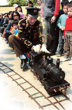 A man's enthusiasm with toys and his train