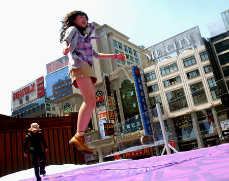 Having fun jumping on giant 'bed'