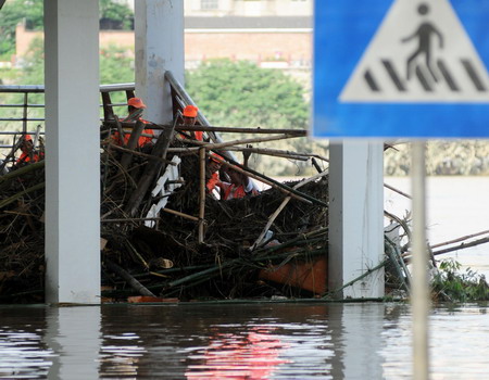 Locals and soldiers clean up after floods